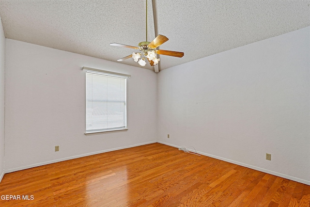 spare room featuring a textured ceiling, ceiling fan, and wood-type flooring