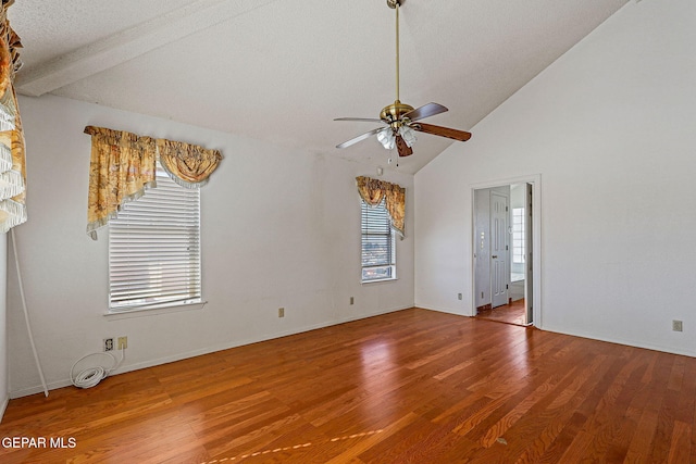 unfurnished room featuring ceiling fan, beam ceiling, wood-type flooring, and high vaulted ceiling