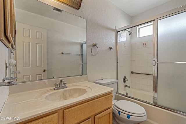 full bathroom with toilet, enclosed tub / shower combo, and vanity