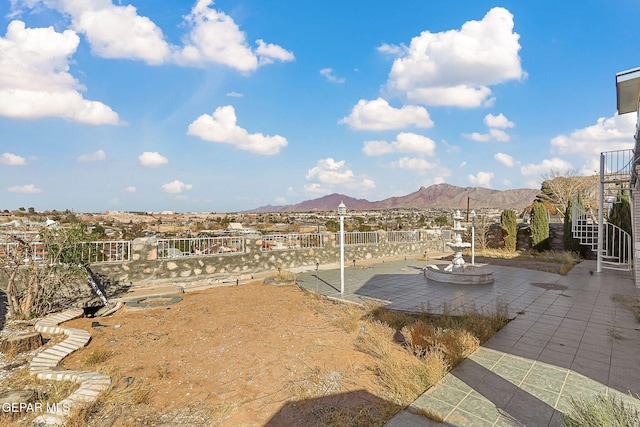 view of yard featuring a mountain view and a patio