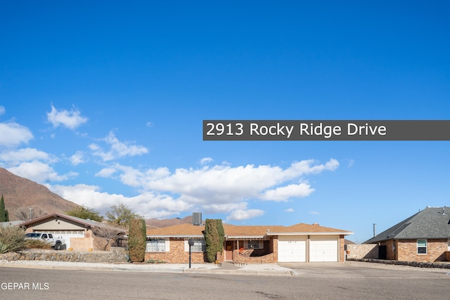 view of front facade featuring a mountain view and a garage