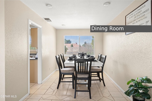 dining area with light tile patterned floors