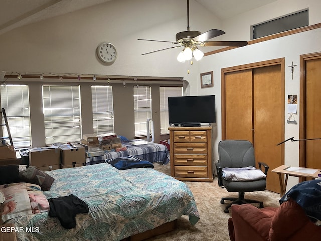 carpeted bedroom featuring vaulted ceiling and ceiling fan