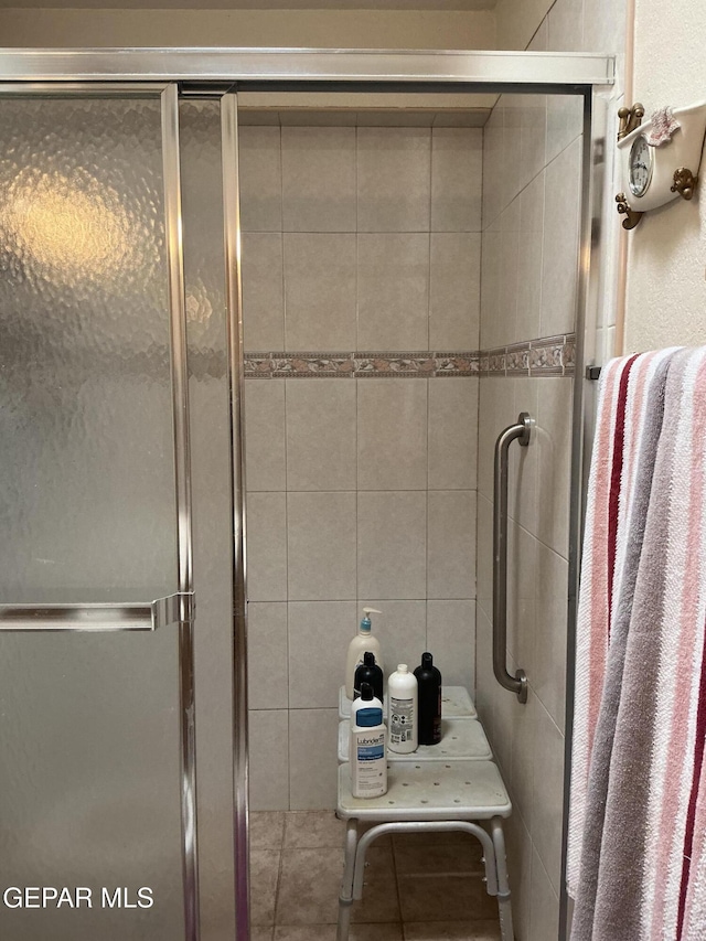 bathroom with a shower with door