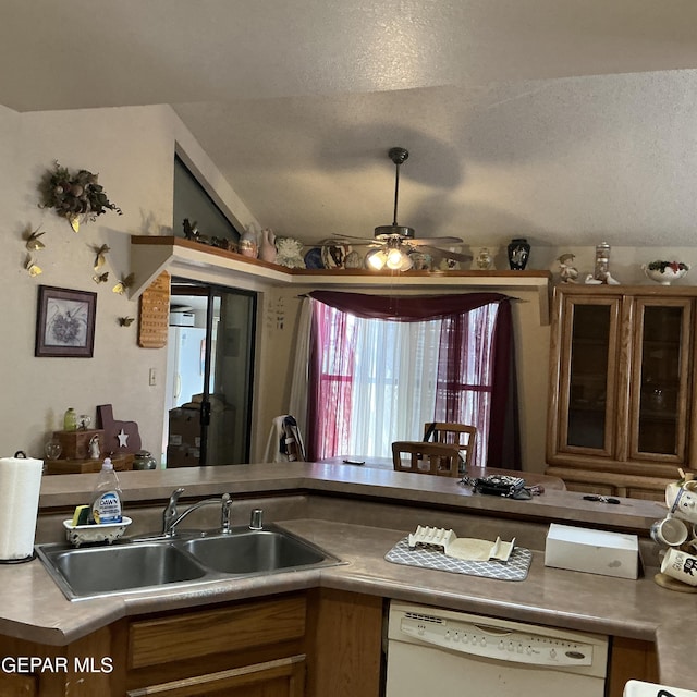 kitchen featuring ceiling fan, lofted ceiling, white dishwasher, and sink