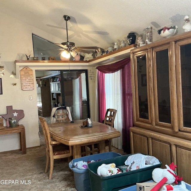 carpeted dining room featuring ceiling fan