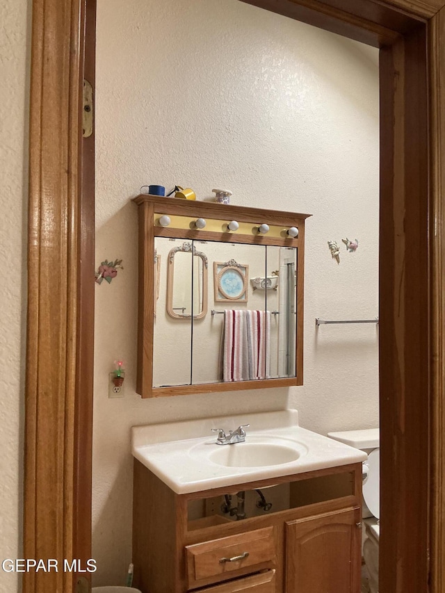 bathroom with vanity and toilet