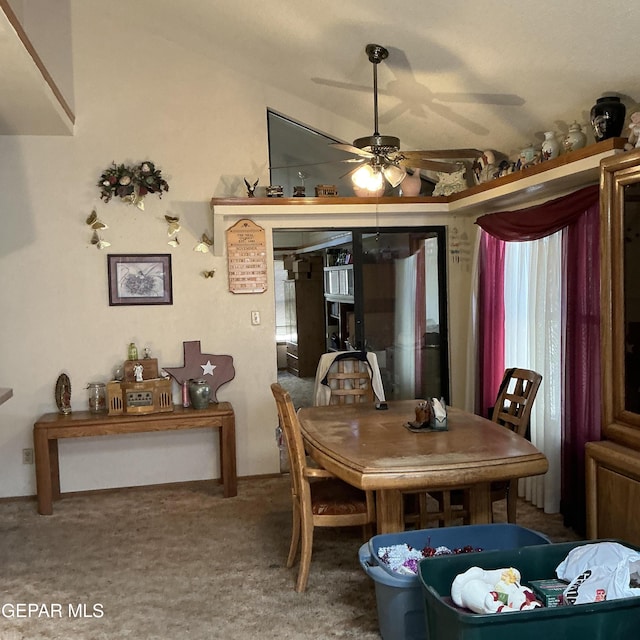 dining room with lofted ceiling, ceiling fan, and carpet flooring