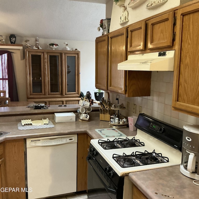 kitchen with white dishwasher, gas range oven, and decorative backsplash