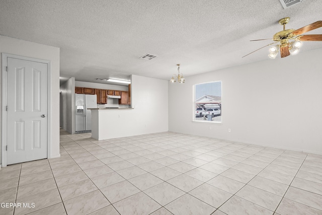 unfurnished living room with ceiling fan with notable chandelier, a textured ceiling, and light tile patterned floors