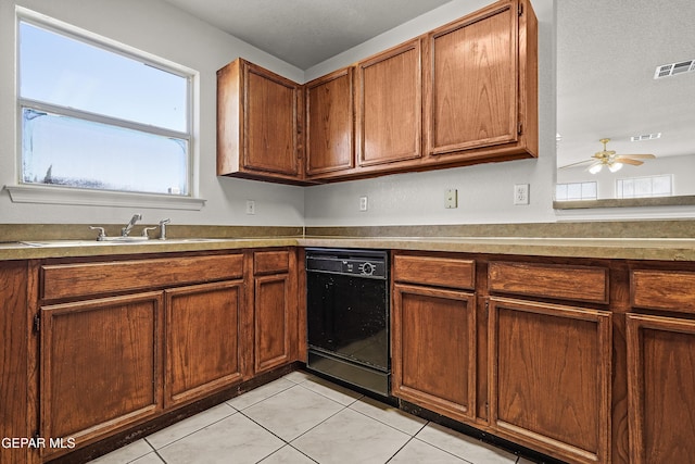 kitchen featuring light tile patterned floors, ceiling fan, black dishwasher, a textured ceiling, and sink