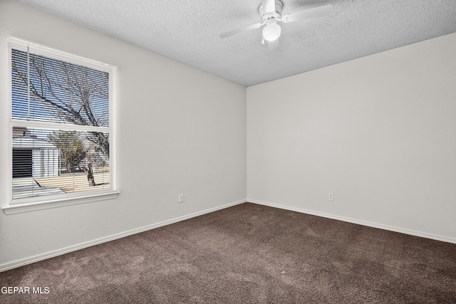 carpeted spare room featuring a textured ceiling and ceiling fan