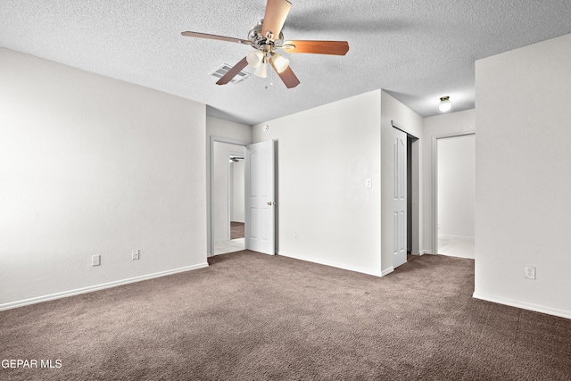 unfurnished bedroom featuring a textured ceiling, ceiling fan, and dark carpet