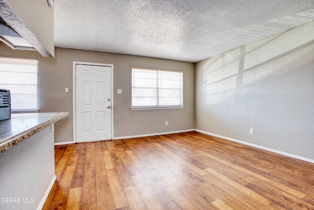 interior space featuring hardwood / wood-style flooring and a textured ceiling