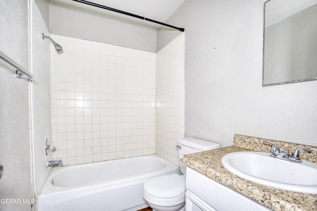 full bathroom featuring toilet, tiled shower / bath combo, and vanity