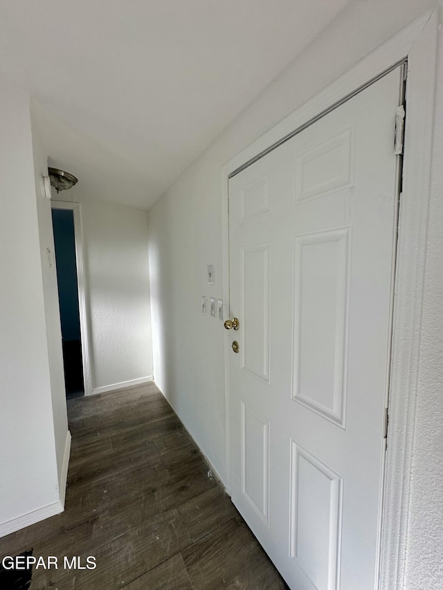 hallway featuring dark hardwood / wood-style flooring