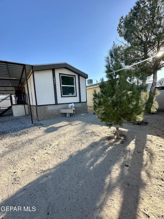 view of home's exterior featuring a carport