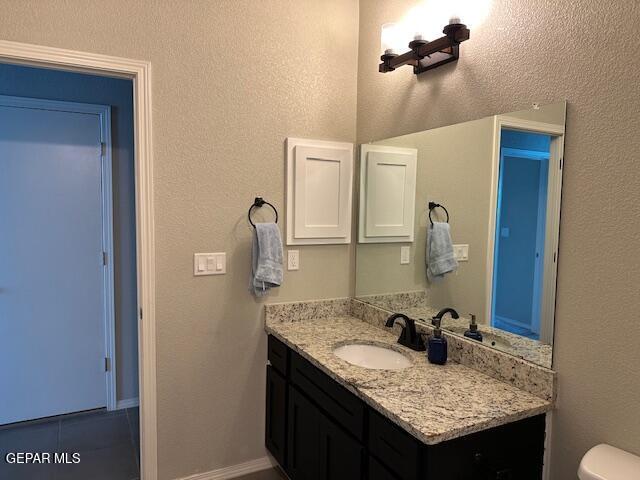 bathroom with toilet and vanity