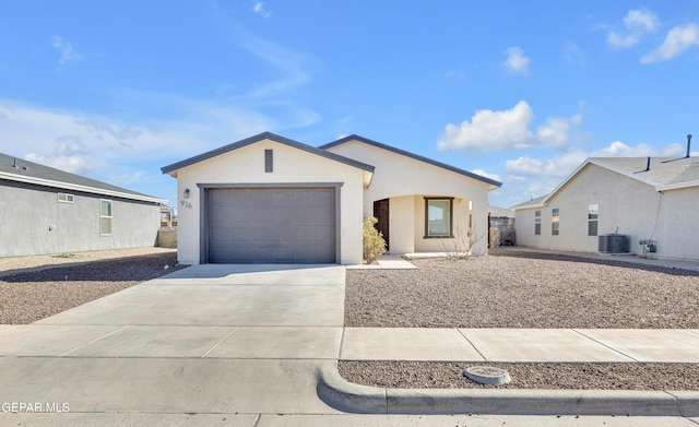 view of front of home featuring a garage and central AC unit