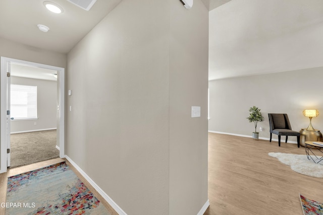 hallway with light hardwood / wood-style floors