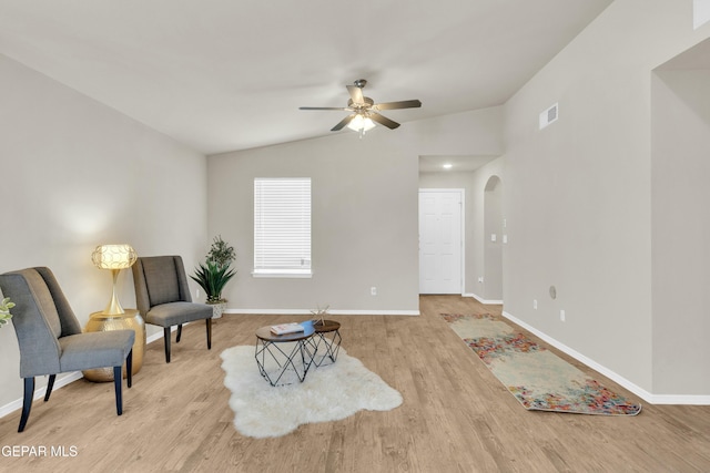 sitting room with vaulted ceiling, ceiling fan, and light hardwood / wood-style floors