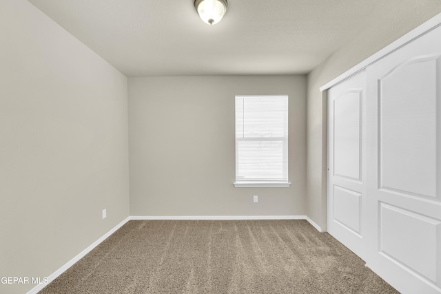 unfurnished bedroom with a closet and carpet