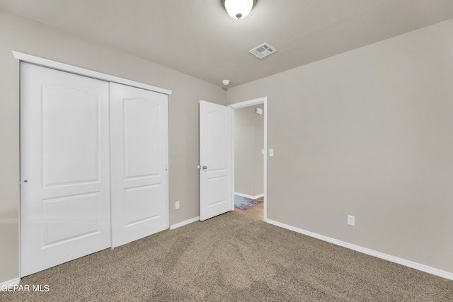 unfurnished bedroom featuring a closet and carpet flooring