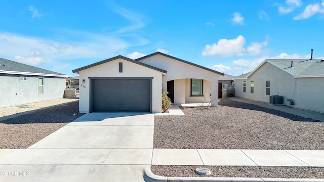 view of front of property with a garage and central AC