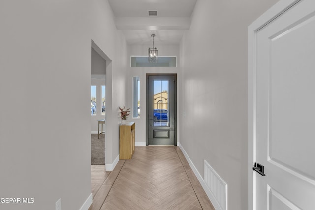 interior space featuring an inviting chandelier and light parquet floors