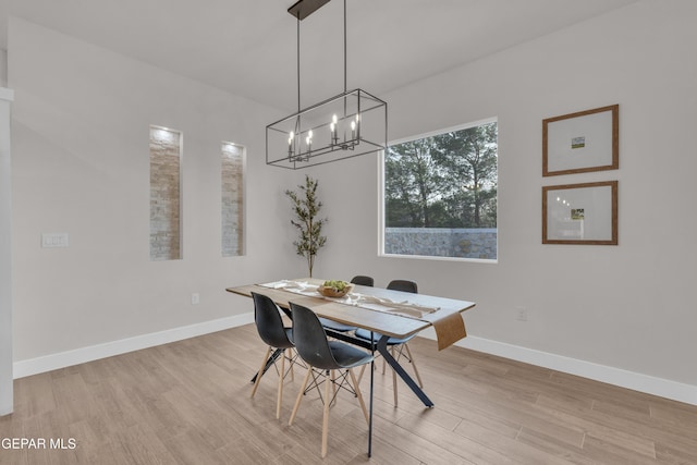 dining area with a chandelier and light wood-type flooring