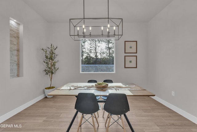 dining area featuring a chandelier and light hardwood / wood-style flooring