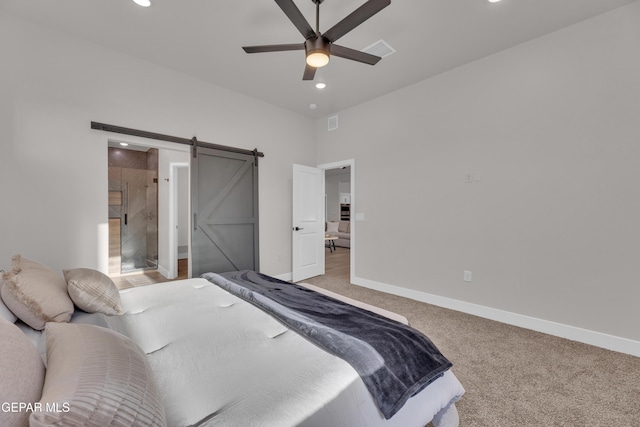 bedroom with ceiling fan, a barn door, and light colored carpet