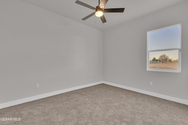 spare room featuring ceiling fan and carpet floors