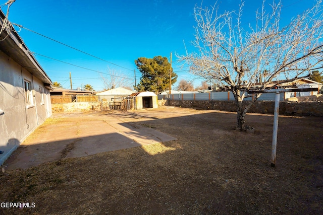 view of yard featuring an outbuilding and a fenced backyard