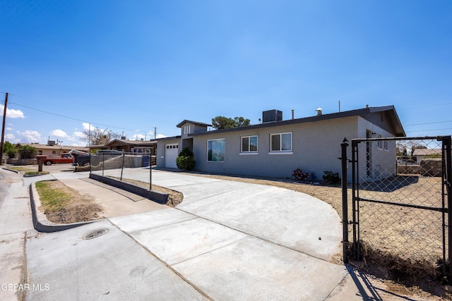678 Lomaland Dr, El Paso, TX 79907 - ranch-style home with concrete driveway, stucco siding, a gate, and an attached garage