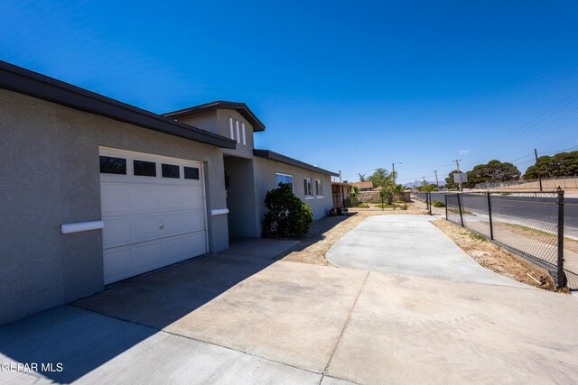 678 Lomaland Dr, El Paso, TX 79907 - view of home's exterior featuring driveway, stucco siding, and a garage