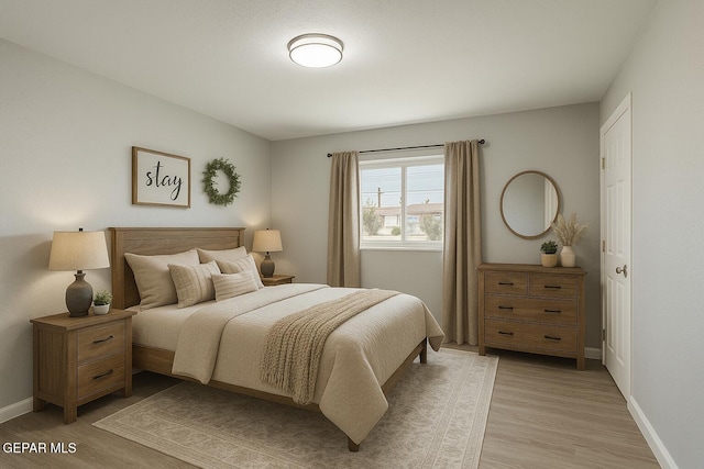 678 Lomaland Dr, El Paso, TX 79907 - bedroom featuring light wood-type flooring and baseboards