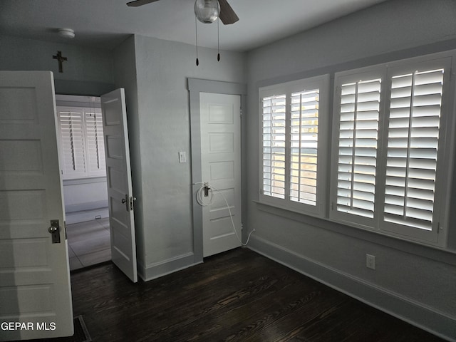 unfurnished bedroom with dark wood-type flooring and ceiling fan