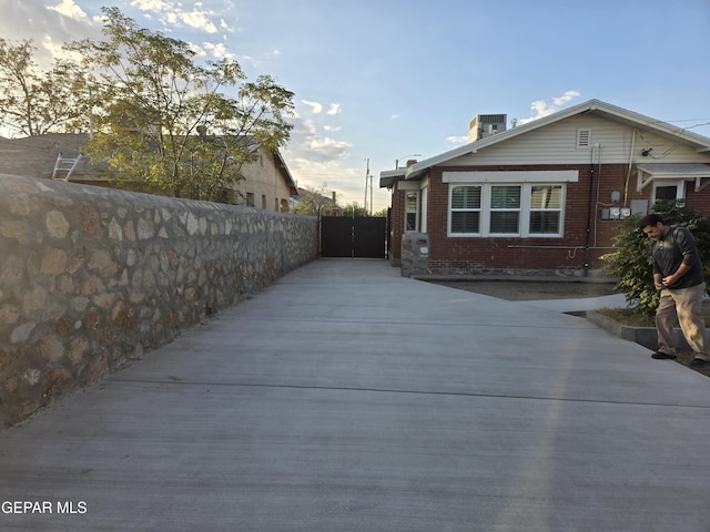 view of side of home featuring central AC