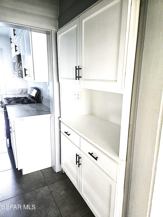 clothes washing area with cabinets and washer and dryer