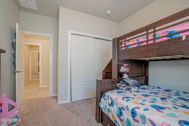 bedroom featuring a closet and light carpet