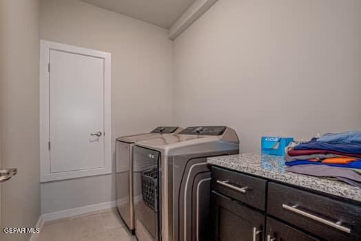 washroom featuring cabinets and washer and dryer