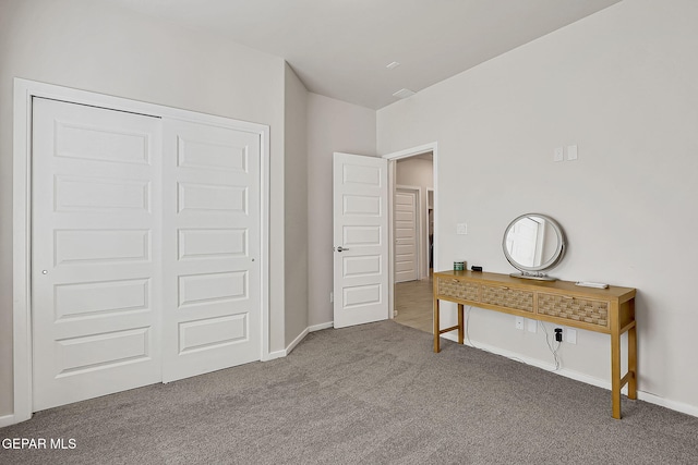 unfurnished bedroom with carpet floors and a closet