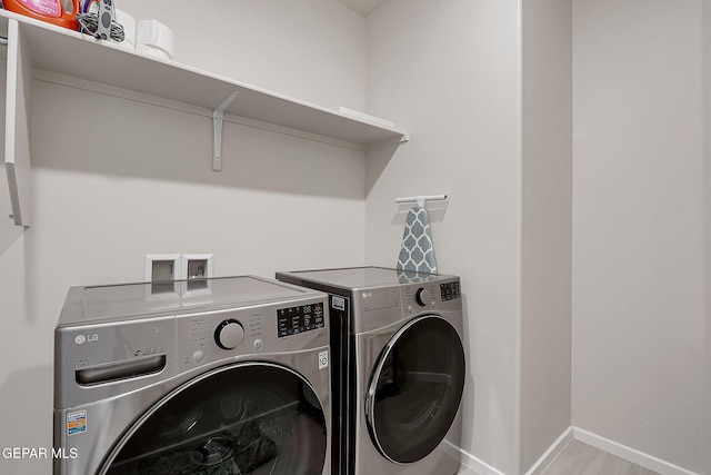 clothes washing area featuring independent washer and dryer