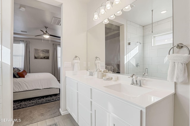 bathroom with ceiling fan, a healthy amount of sunlight, vanity, and a shower with door