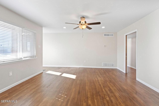 empty room featuring ceiling fan and dark hardwood / wood-style floors