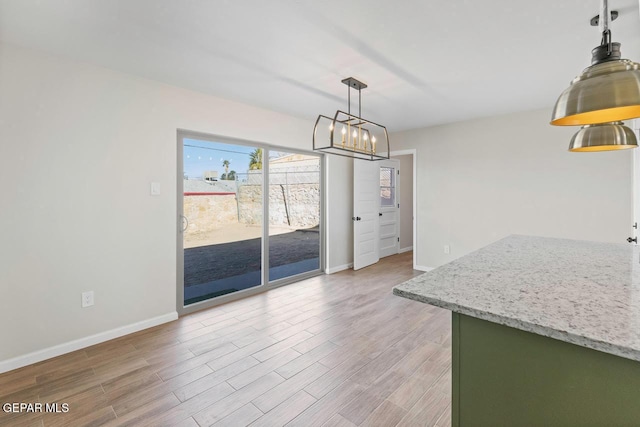 unfurnished dining area featuring a notable chandelier