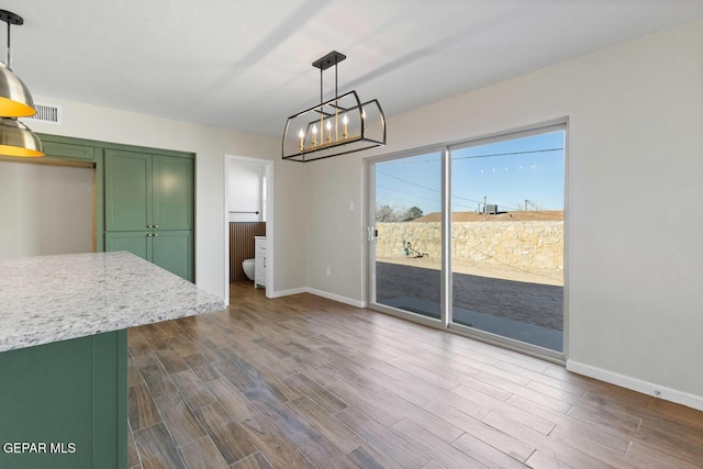 unfurnished dining area featuring hardwood / wood-style flooring