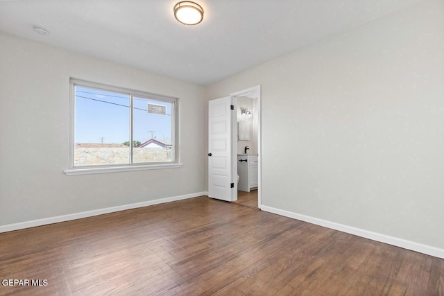 unfurnished bedroom featuring dark hardwood / wood-style flooring