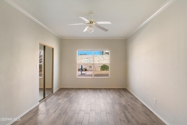 unfurnished room with hardwood / wood-style floors, crown molding, and a healthy amount of sunlight